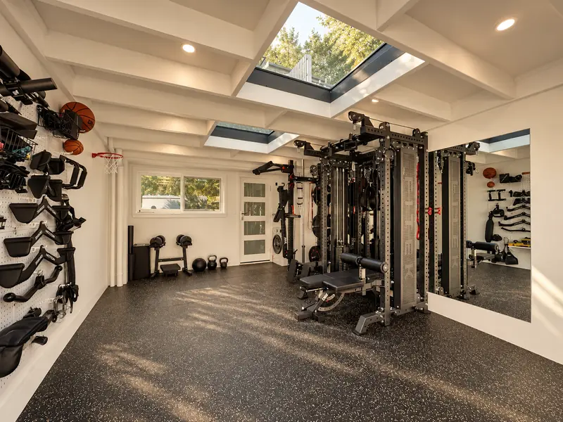 Home gym conversion with a skylight, mirrored wall and exercise equipment