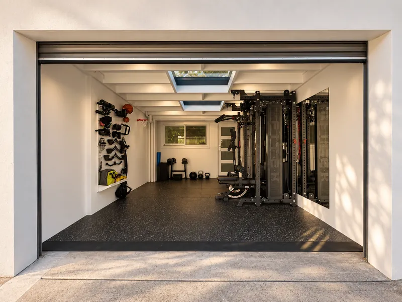 Garage converted into a home gym with skylights and rubber flooring