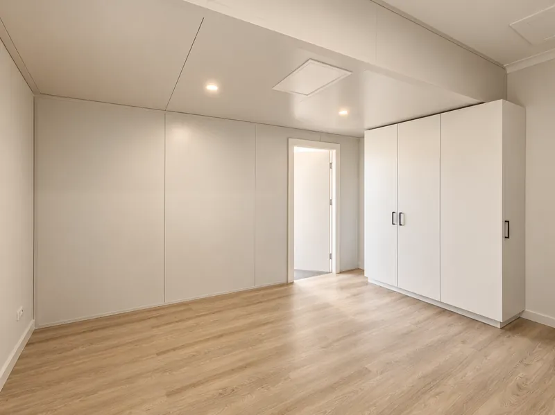 QuickRooms panelled room with built-in wardrobes and timber-look flooring