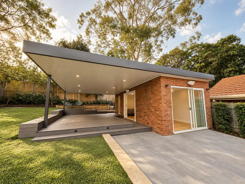 Garden room conversion opening onto a covered outdoor area